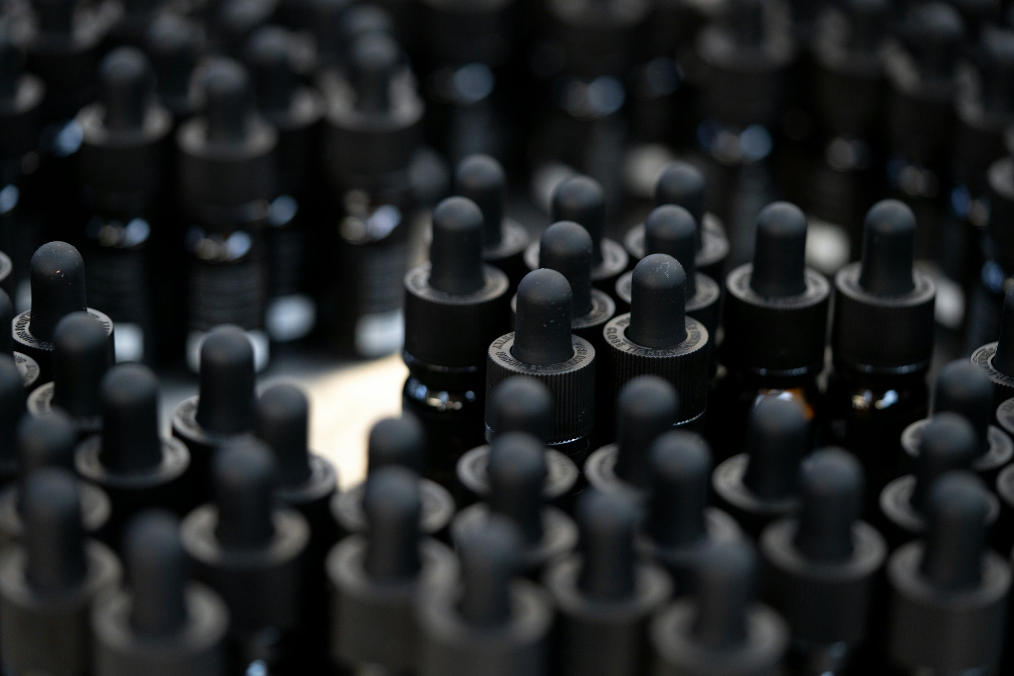 a bunch of black plastic caps sitting on top of a table