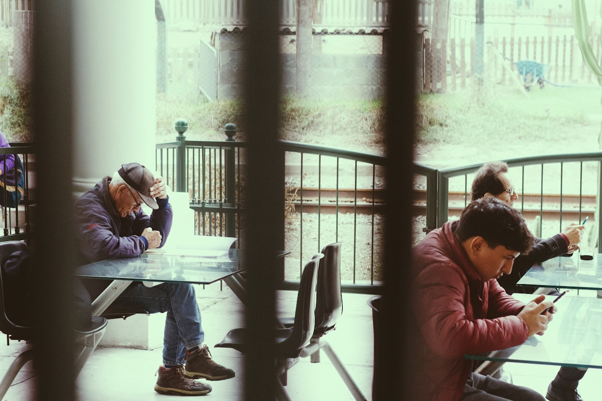 A couple of people sitting at a table next to each other