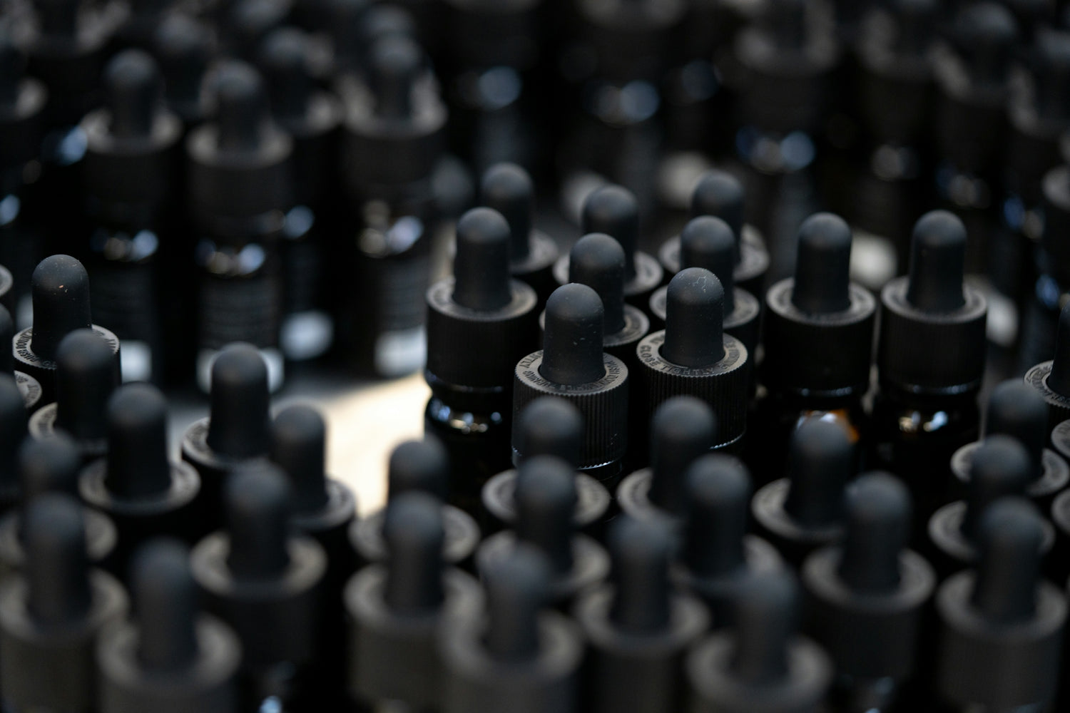 a bunch of black plastic caps sitting on top of a table